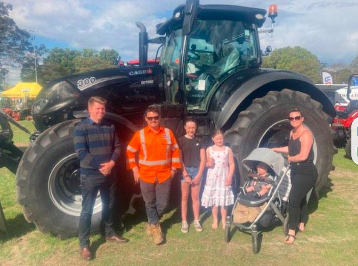 Caption: The only black tractor in Australia is now in the hands of Anthony Warr and his family, pictured with Daniel Arthur at the Berry Small Farm Field Day. Credit: South Coast Register. 